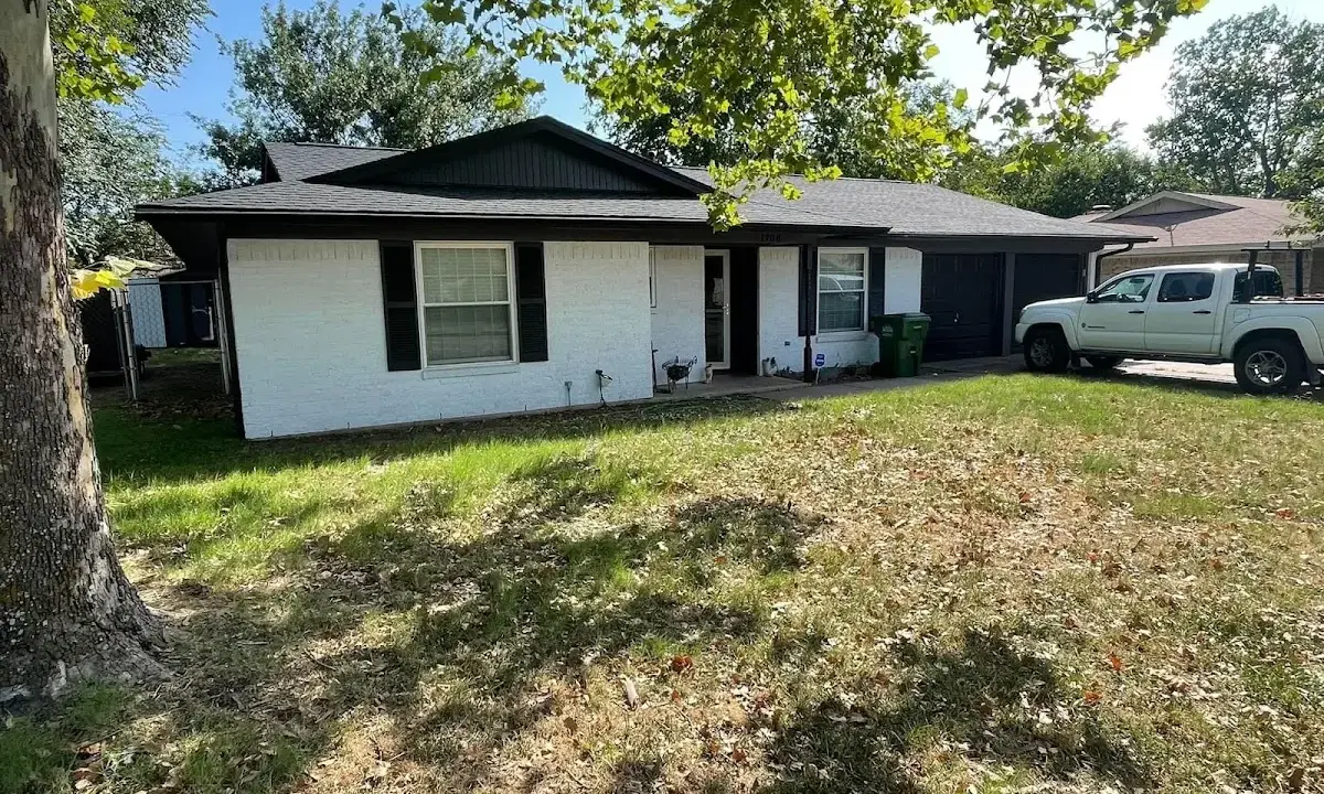 Professional roofing crew working on a residential roof in Grafton